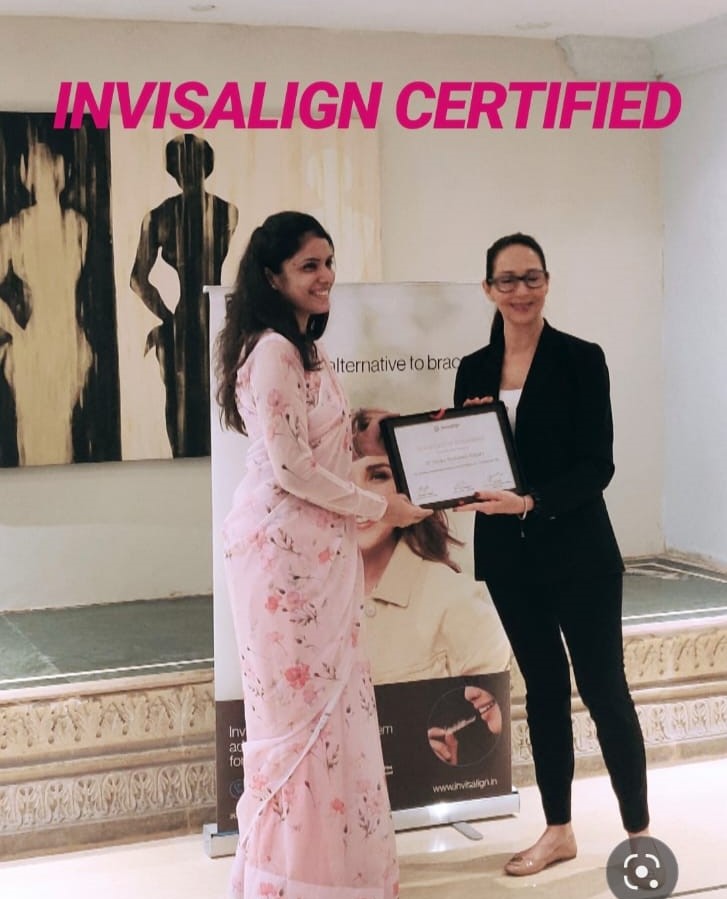 Dr. Honey receiving invisalign certified award from a lady