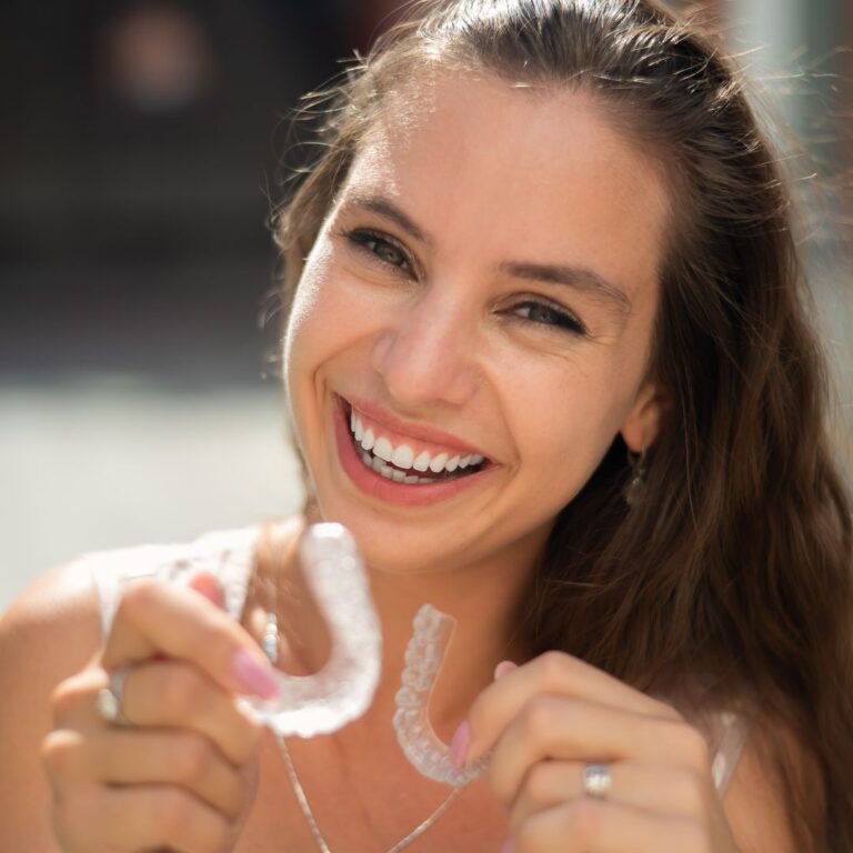 Women carrying mouth guard and smiling